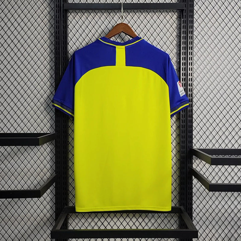 camisa-al-nassr-home-1-titular-2022-23-duneus-torcedor-masculina-masculino-amarela-amarelo-azul-cr7-cristiano-ronaldo-alvaro-gonzalez-luiz-gustavo-arabia-shurfah
