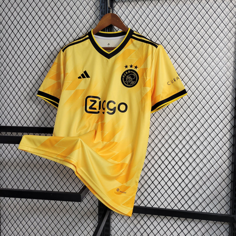 camisa-masculina-adidas-ajax-2023-24-torcedor-amarelo-amarela-preto-preta-ziggo-curaçao-giganet-gola-v
