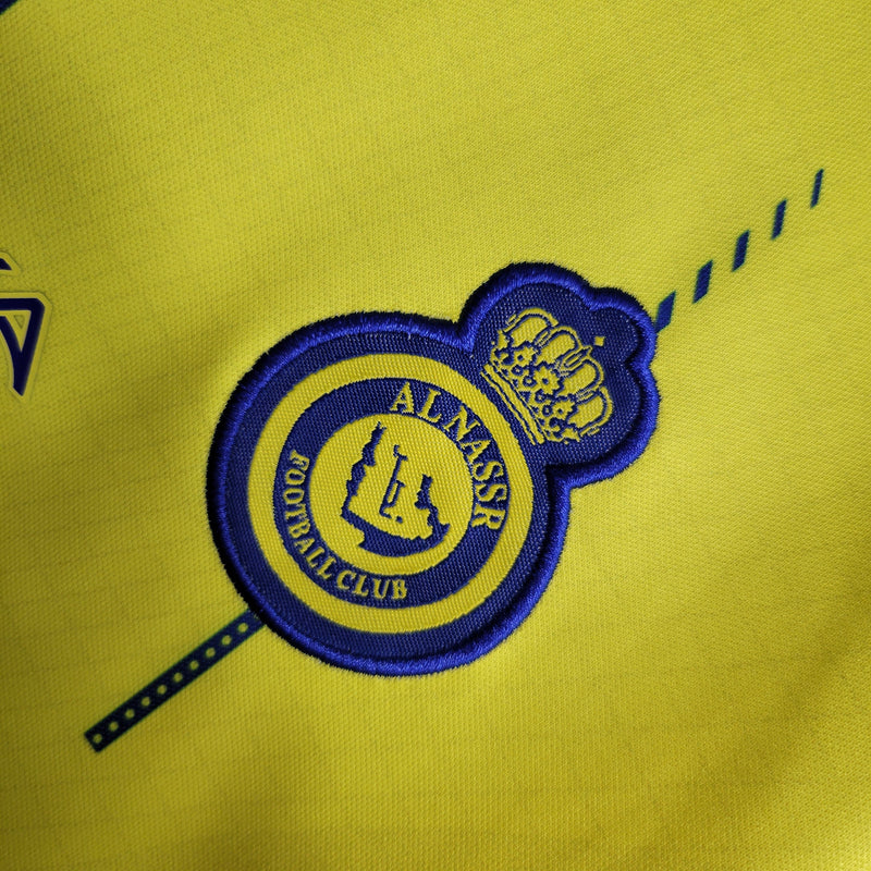 kit-conjunto-infantil-camisa-shorts-al-nassr-home-1-titular-2023-24-nike-torcedor-masculina-masculino-azul-amarelo-amarela-cr7-cristiano-ronaldo-talisca-mane-kafd-aroya-arabia-saudita
