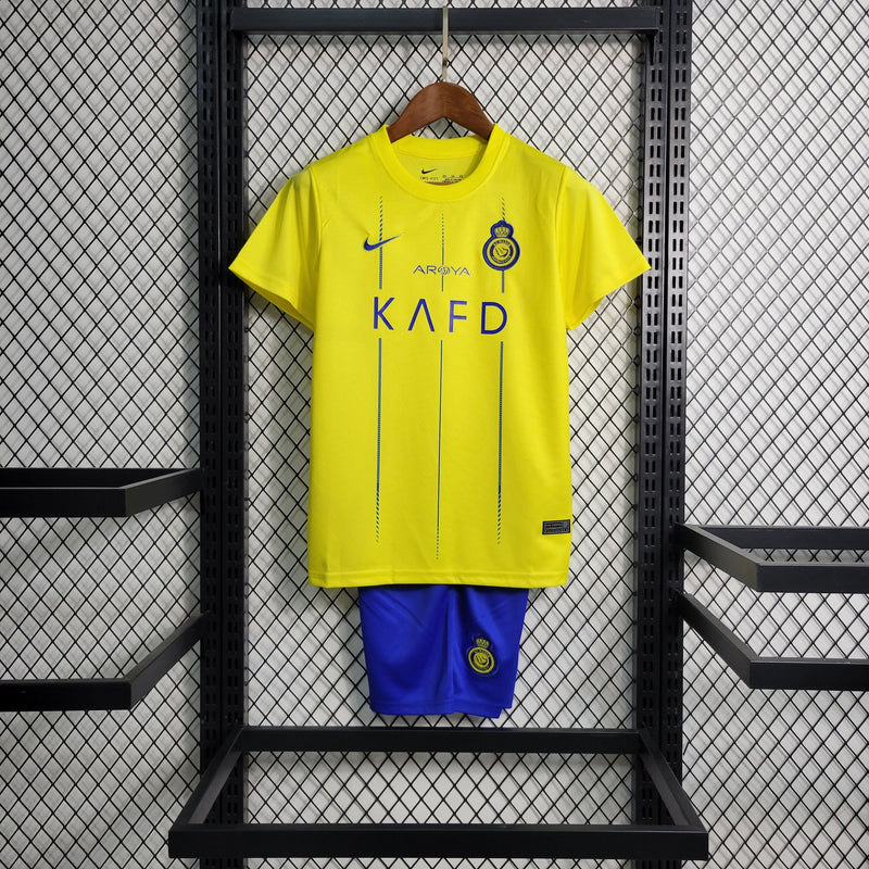 kit-conjunto-infantil-camisa-shorts-al-nassr-home-1-titular-2023-24-nike-torcedor-masculina-masculino-azul-amarelo-amarela-cr7-cristiano-ronaldo-talisca-mane-kafd-aroya-arabia-saudita
